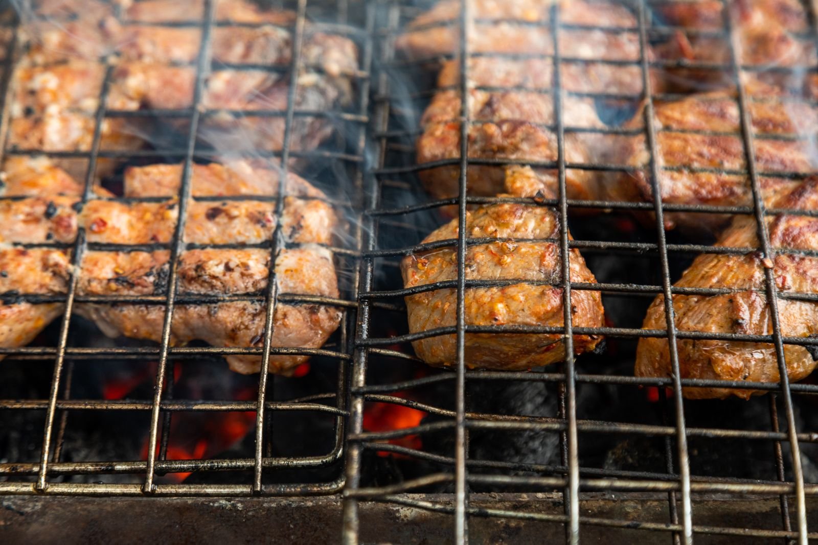 Guests enjoying a relaxed barbeque near a crackling fire