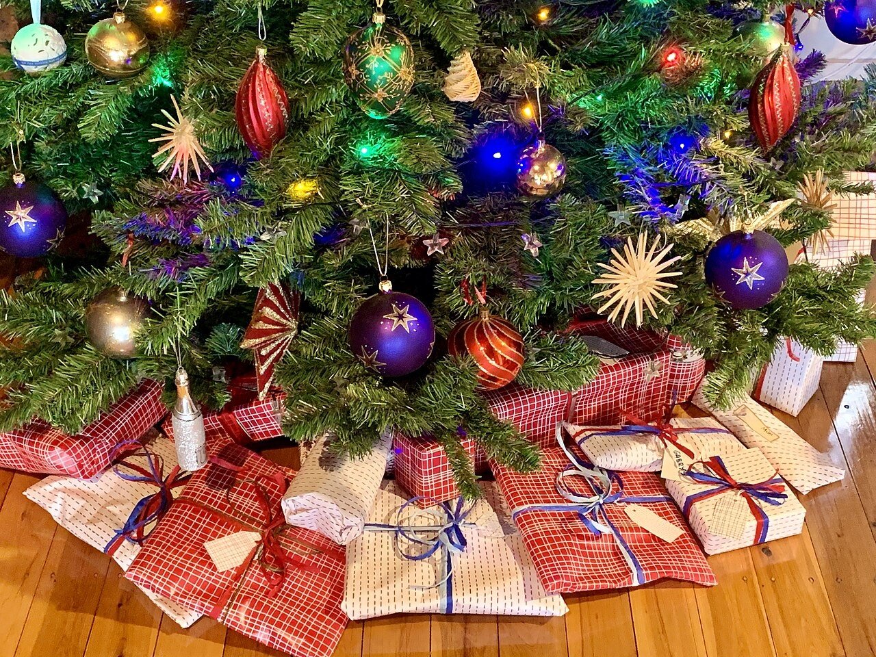 Christmas presents under a tree in a living room