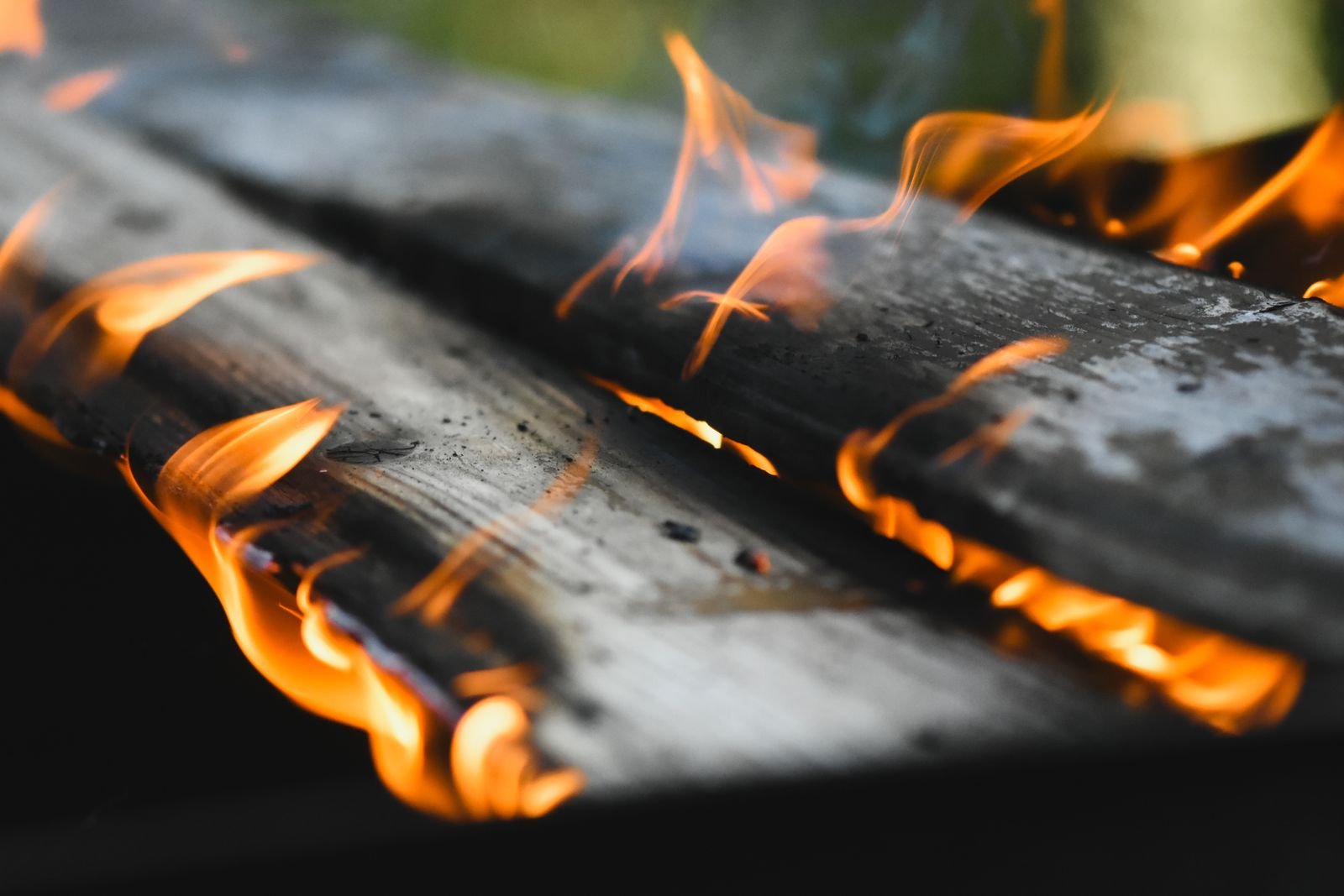 A burning fire with sparks rising into the night air