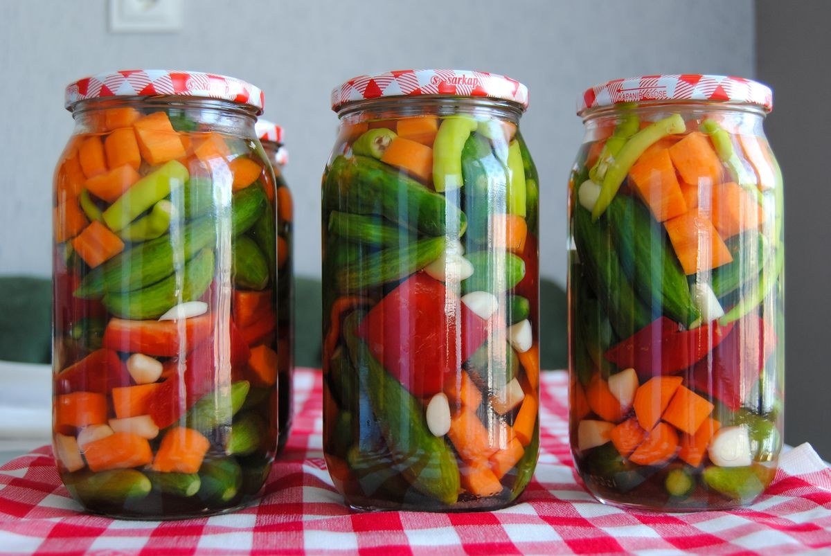 Cooling canned beet jars on a towel with sealed lids being tested