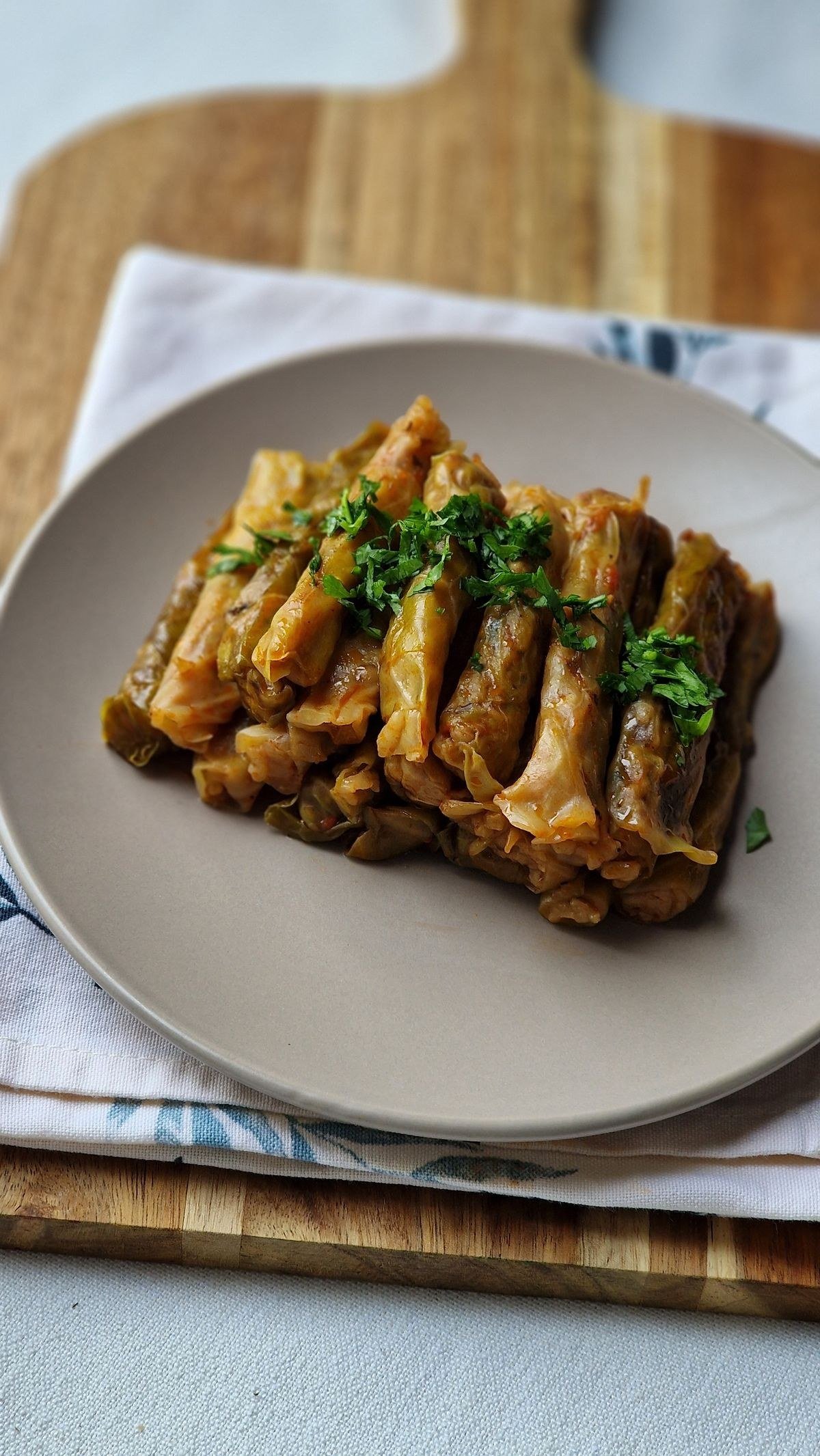 Traditional Polish golumpki cabbage rolls beside a bowl of deconstructed soup