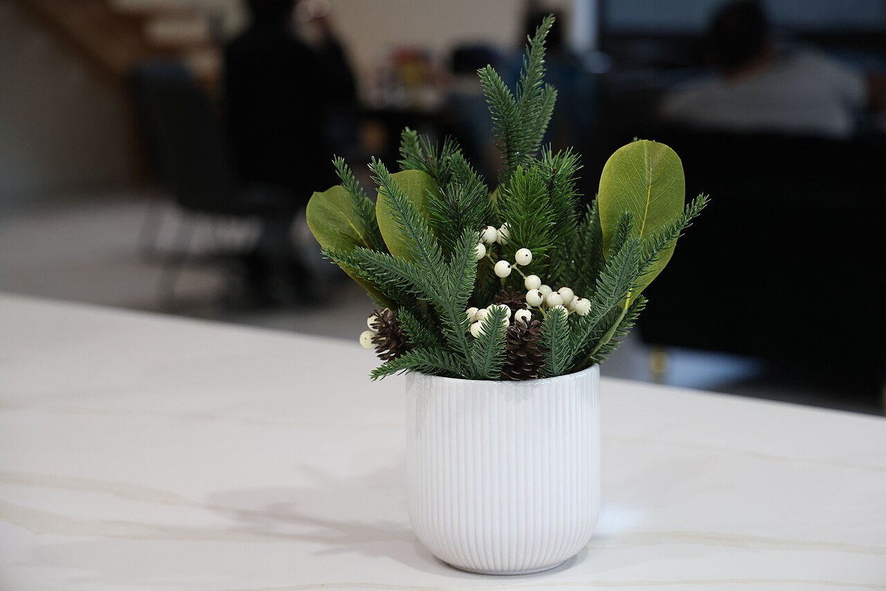 Winter table centerpiece with pinecones and berries