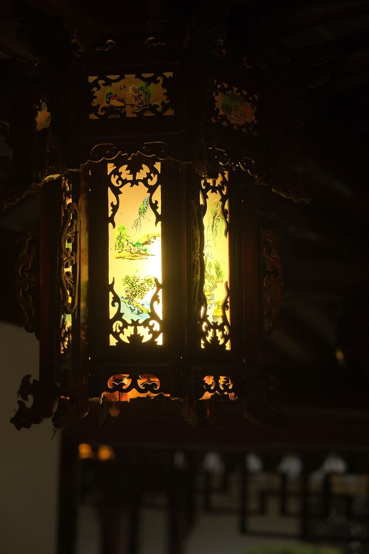 Garden lantern glowing at night in winter