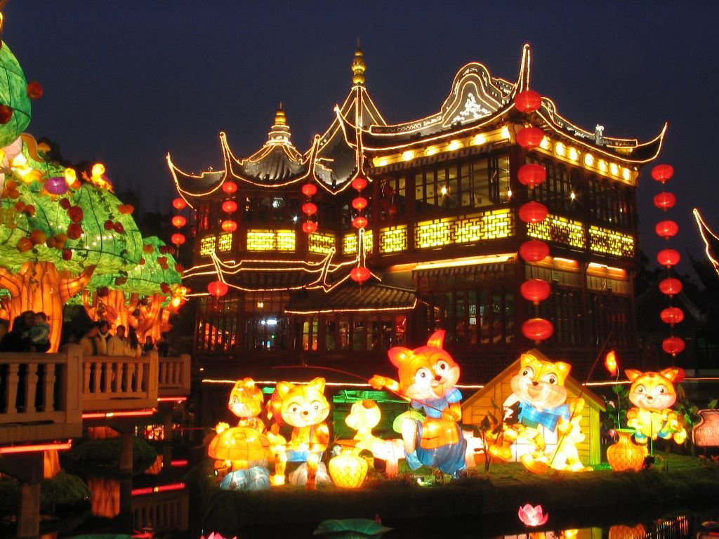 Illuminated garden at night with glowing lanterns