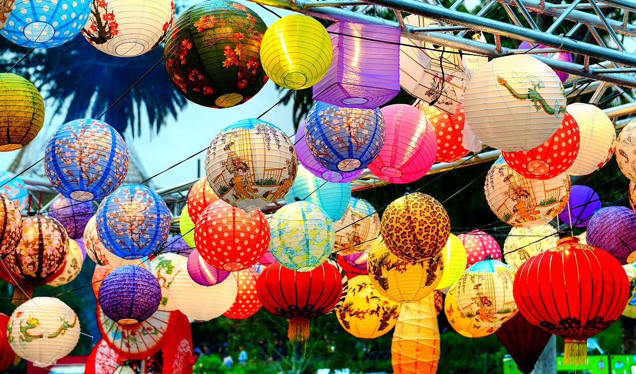Lanterns glowing at an outdoor night gathering