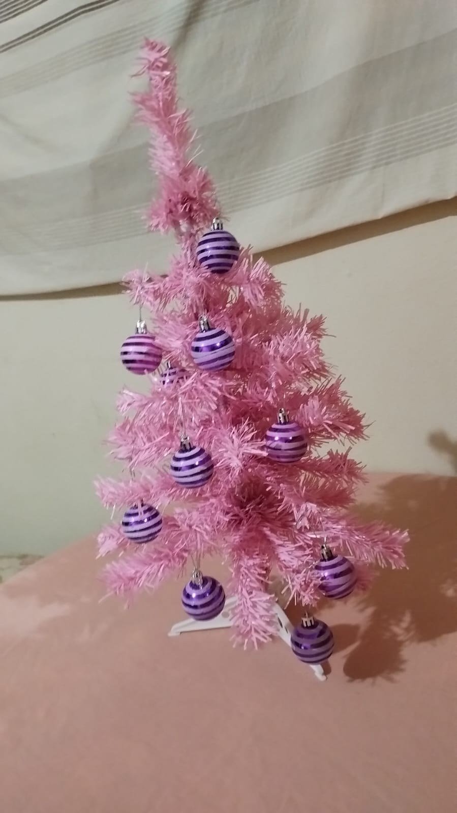 Rose gold ribbon cascading through a pink Christmas tree