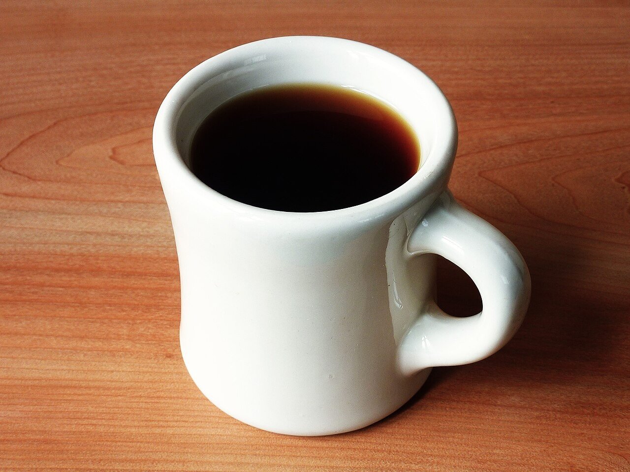 White coffee mug filled with coffee