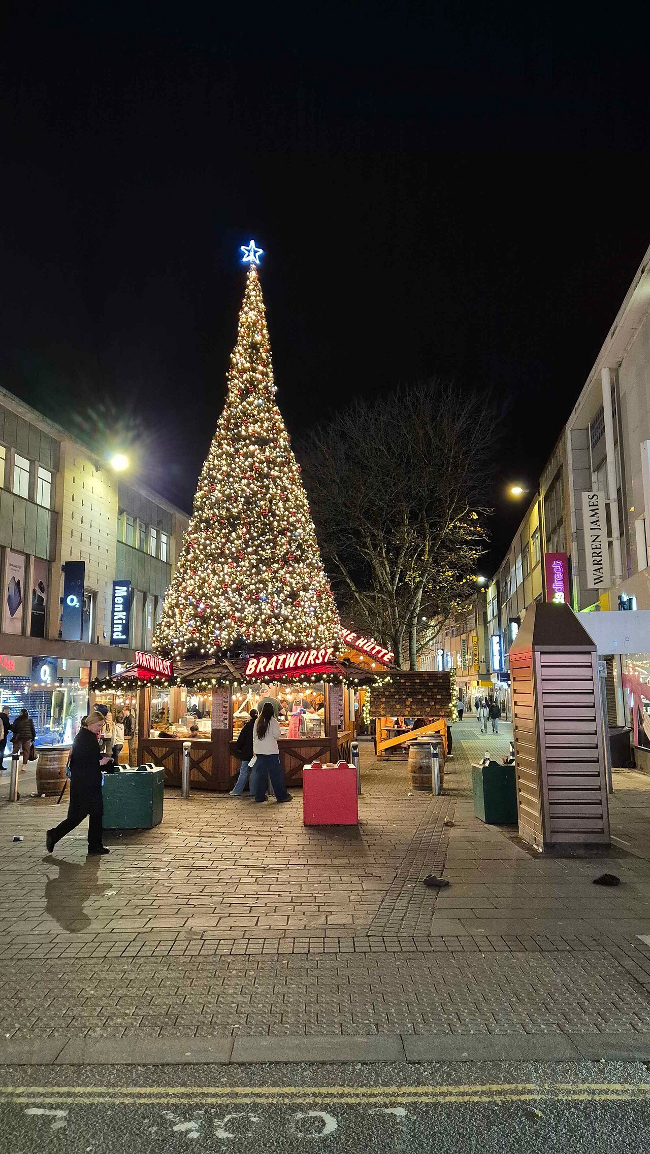Christmas market stalls glowing at night