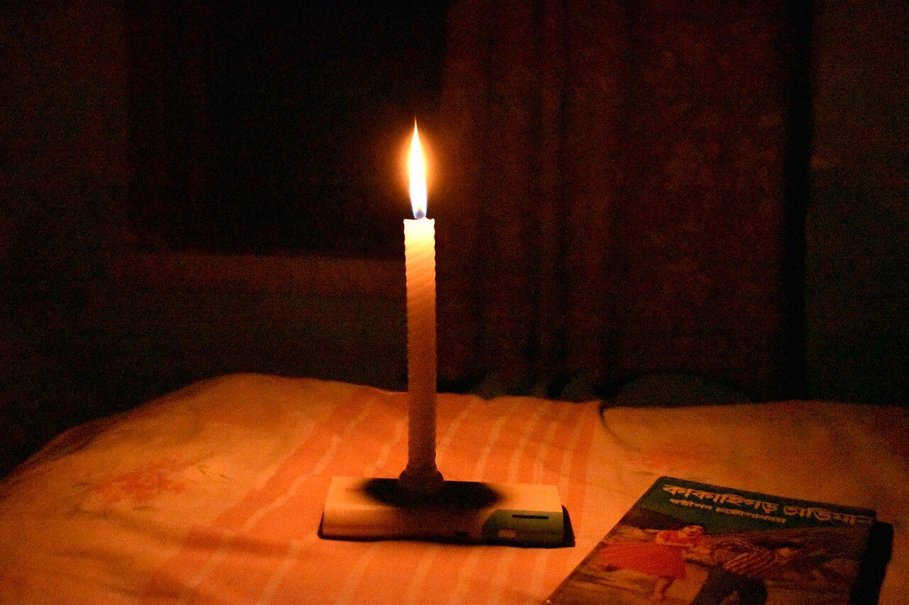 Tea lights flickering in darkness