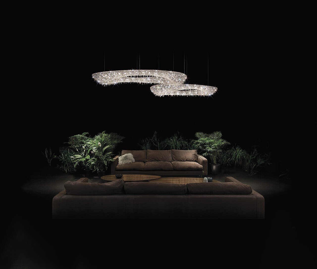 Cluster of modern crystal chandeliers glowing