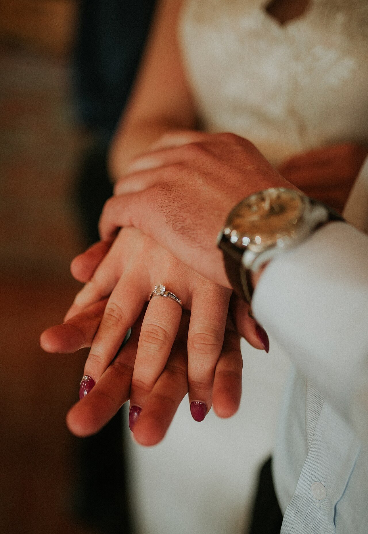 Couple holding hands showing wedding rings