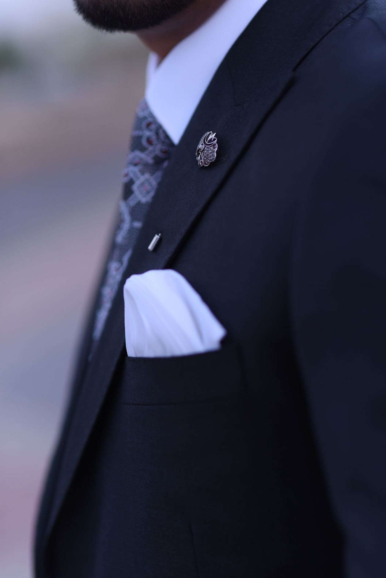 Brooches matched with different coloured suits