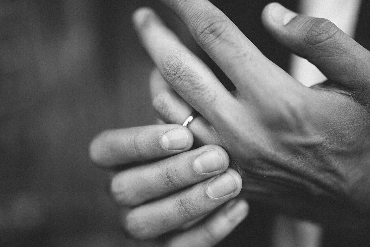 Groom touching his wedding band