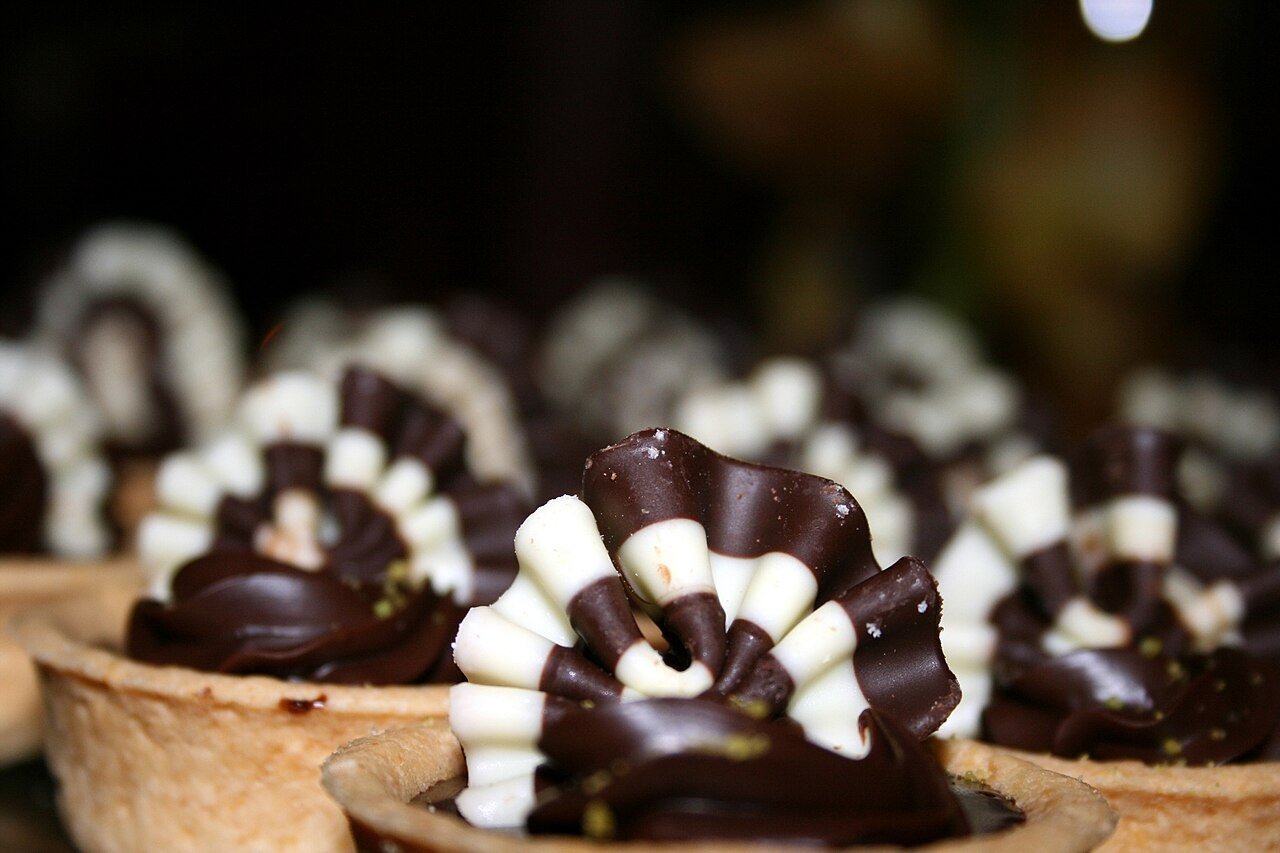 Glossy chocolate tarts ready for dessert