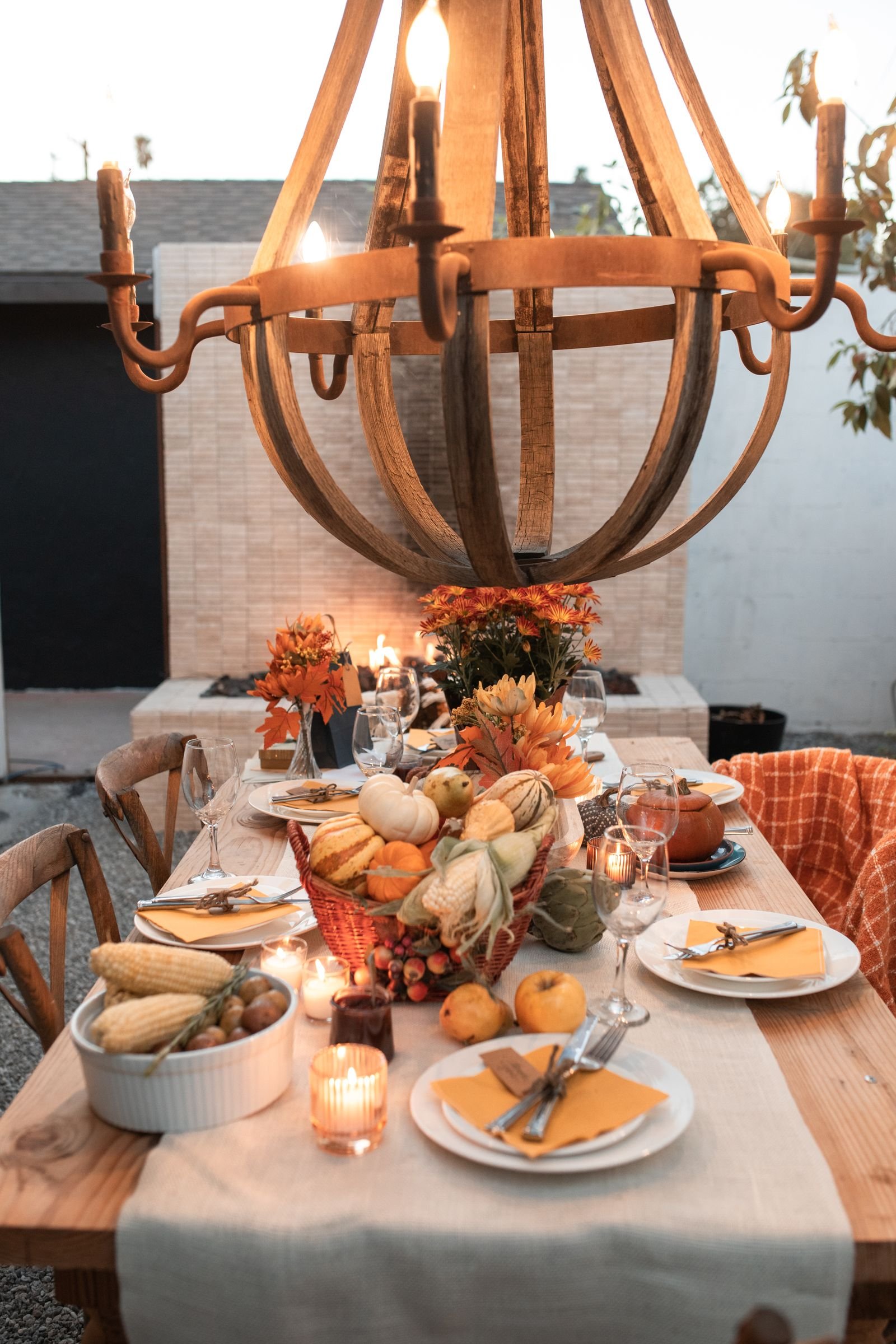 Cozy fall tablescape with pumpkins, candles and rustic decor details