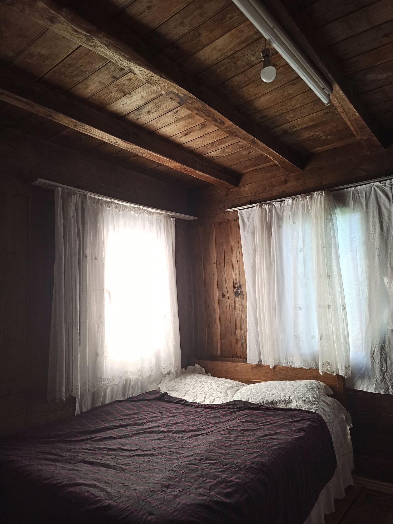 Peaceful farmhouse cottage bedroom with layered bedding