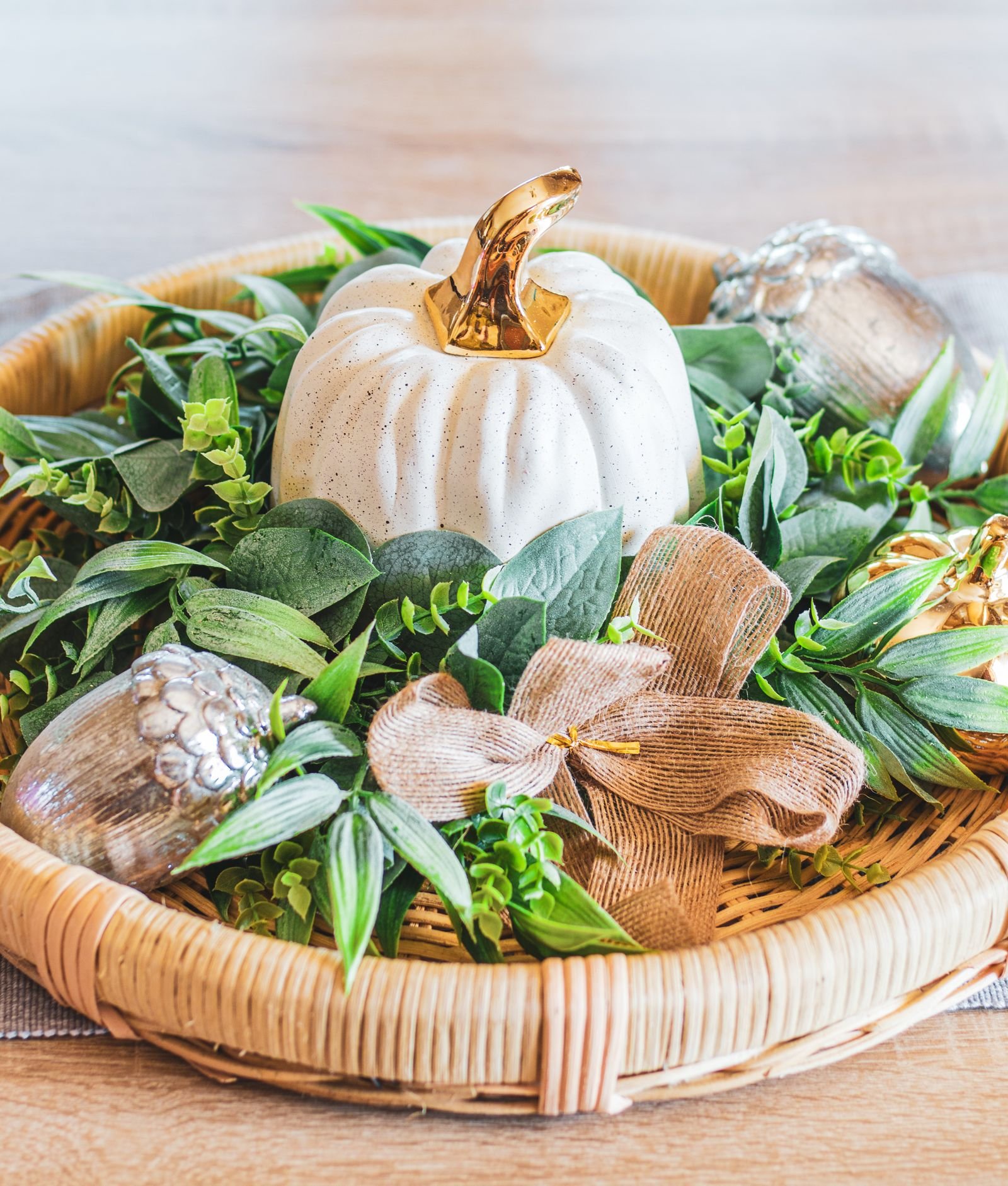 Autumn tray with pumpkin, greenery and metallic accents as centrepiece