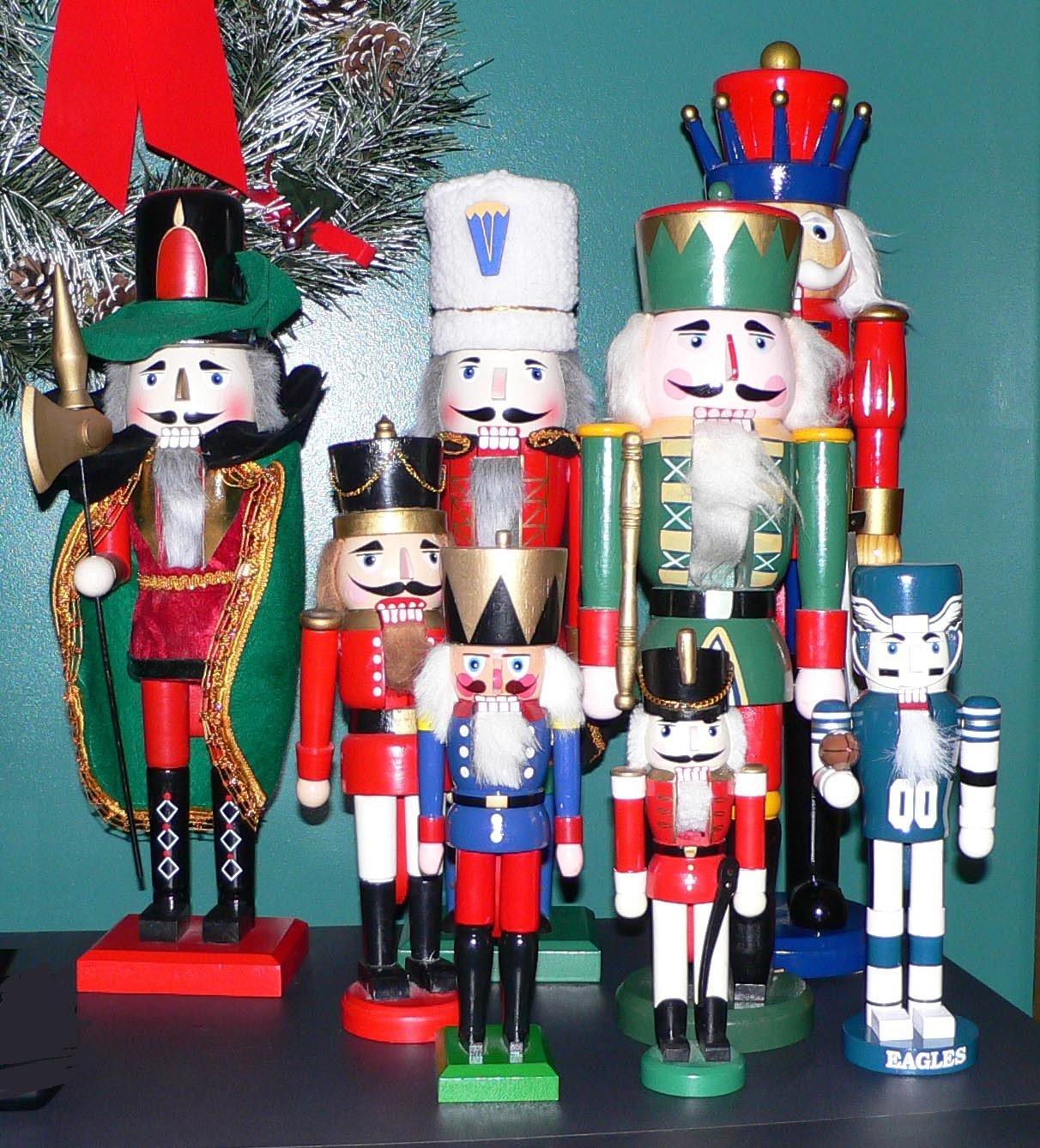 Child decorating a small Nutcracker themed Christmas tree