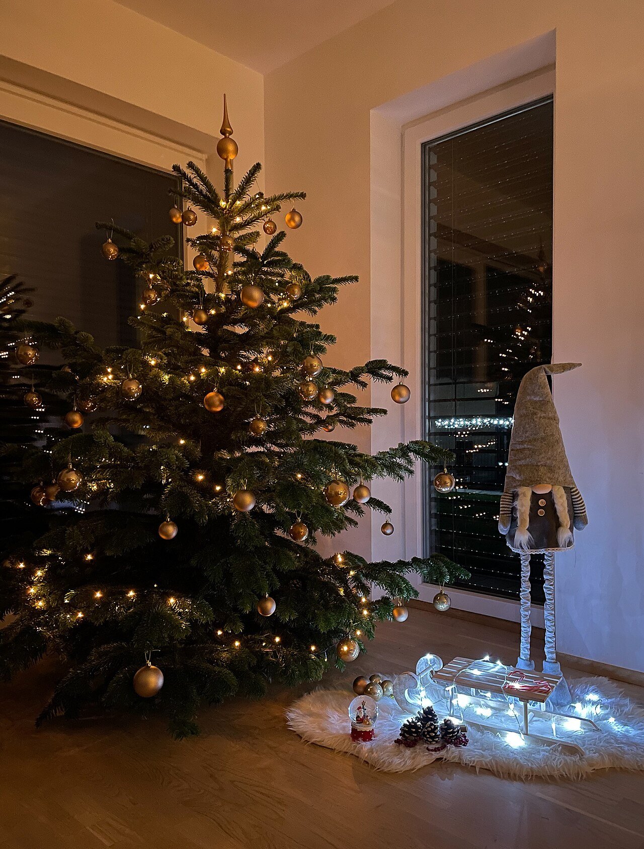 Christmas tree decorated with boho ornaments and golden lights