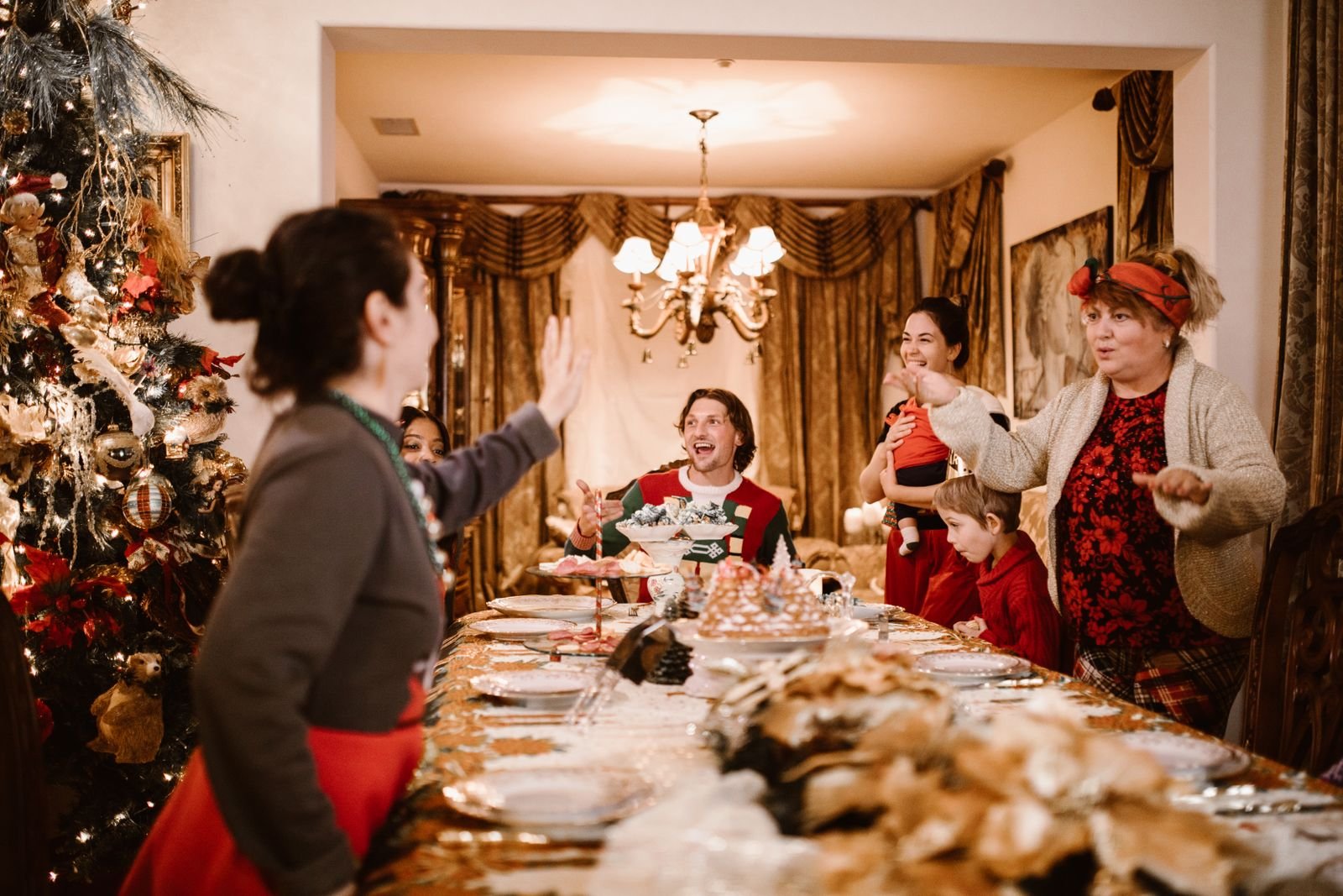 Festive Christmas dinner table evolving from a Thanksgiving harvest setting