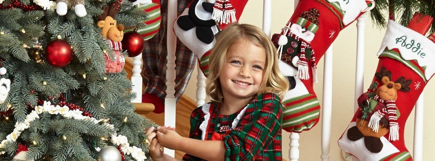 Personalized Christmas stockings hanging on a staircase banister