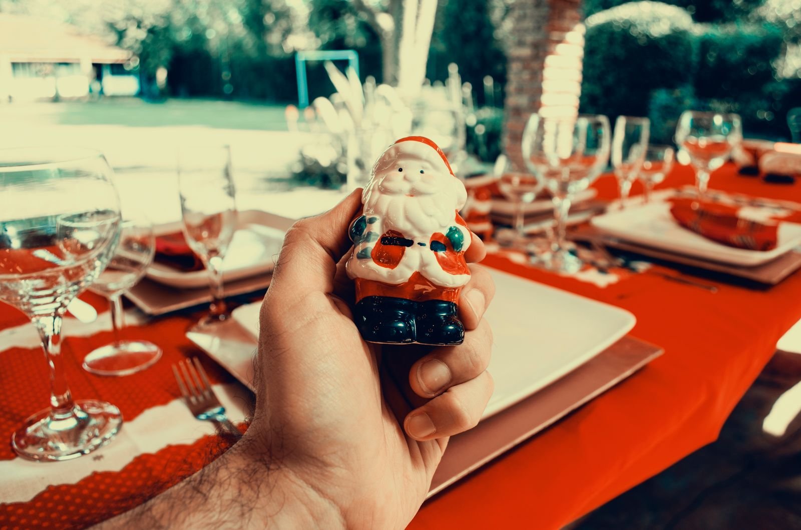 Santa Claus figurine displayed at a festive outdoor holiday table setting